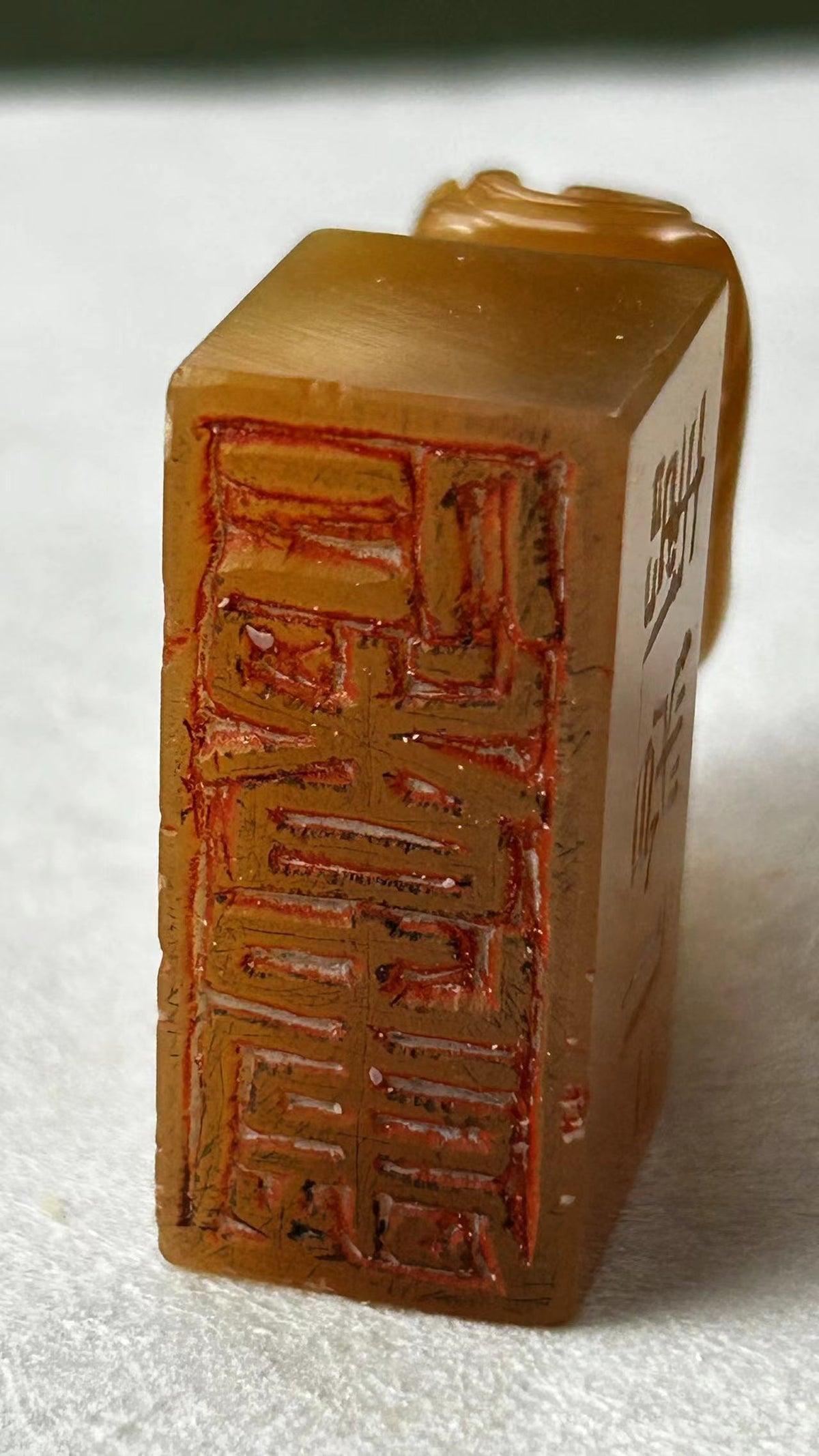 Close‑up of Tianhuang stone seal, showing carved seal face with carving traces