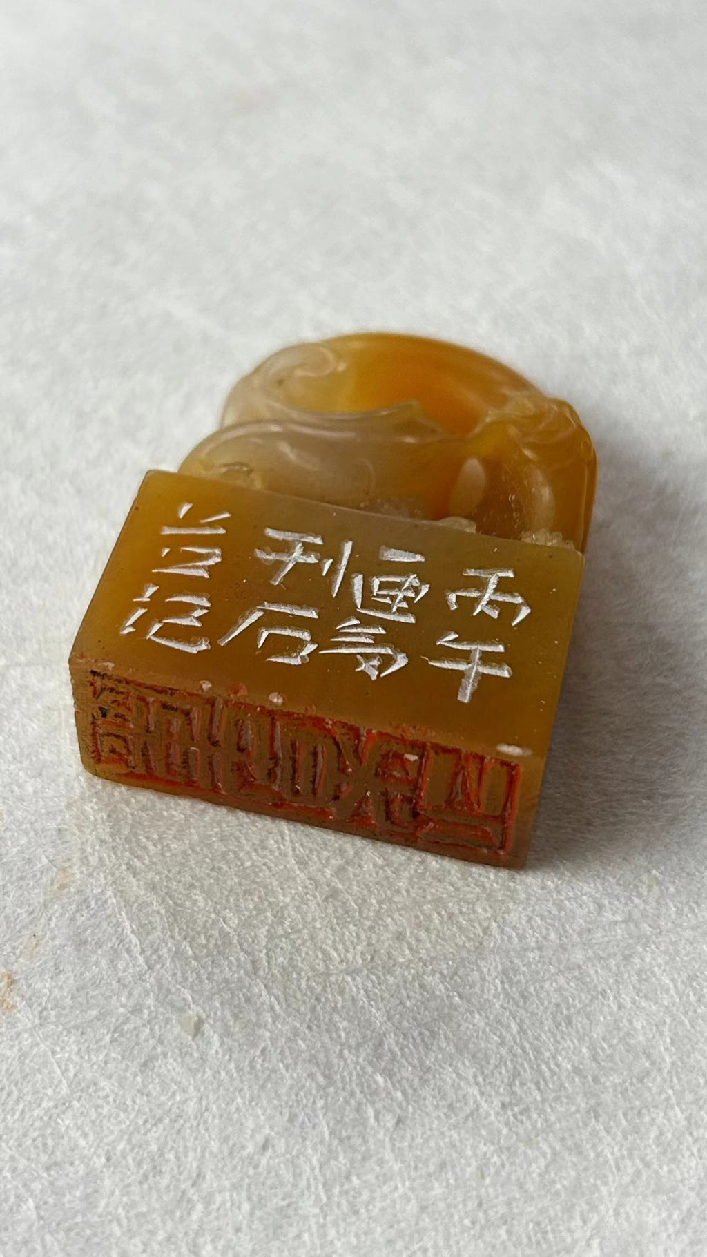 Angled shot showing seal face and hand‑engraved side colophon inscriptions