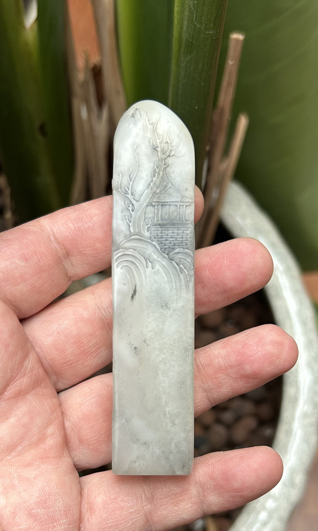 Shoushan Stone tall square seal blank 2.1x2.1x9.5cm hand carved landscape relief side view studio shot held in hand 