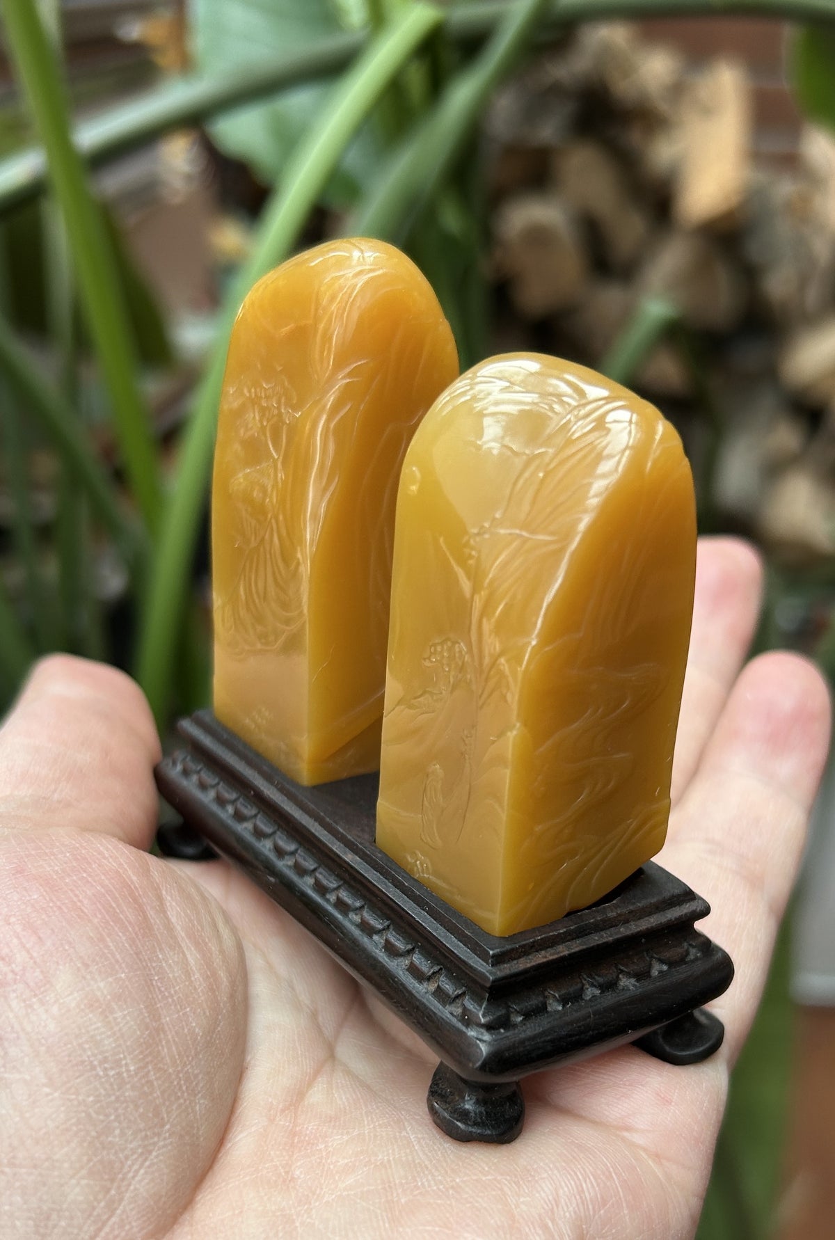 Laos Northern Malt Tian Huang Stone seal pair 2.3x2.3x6cm 2.2x2.2x5.3cm hand carved landscape relief studio shot held in hand with wooden stand