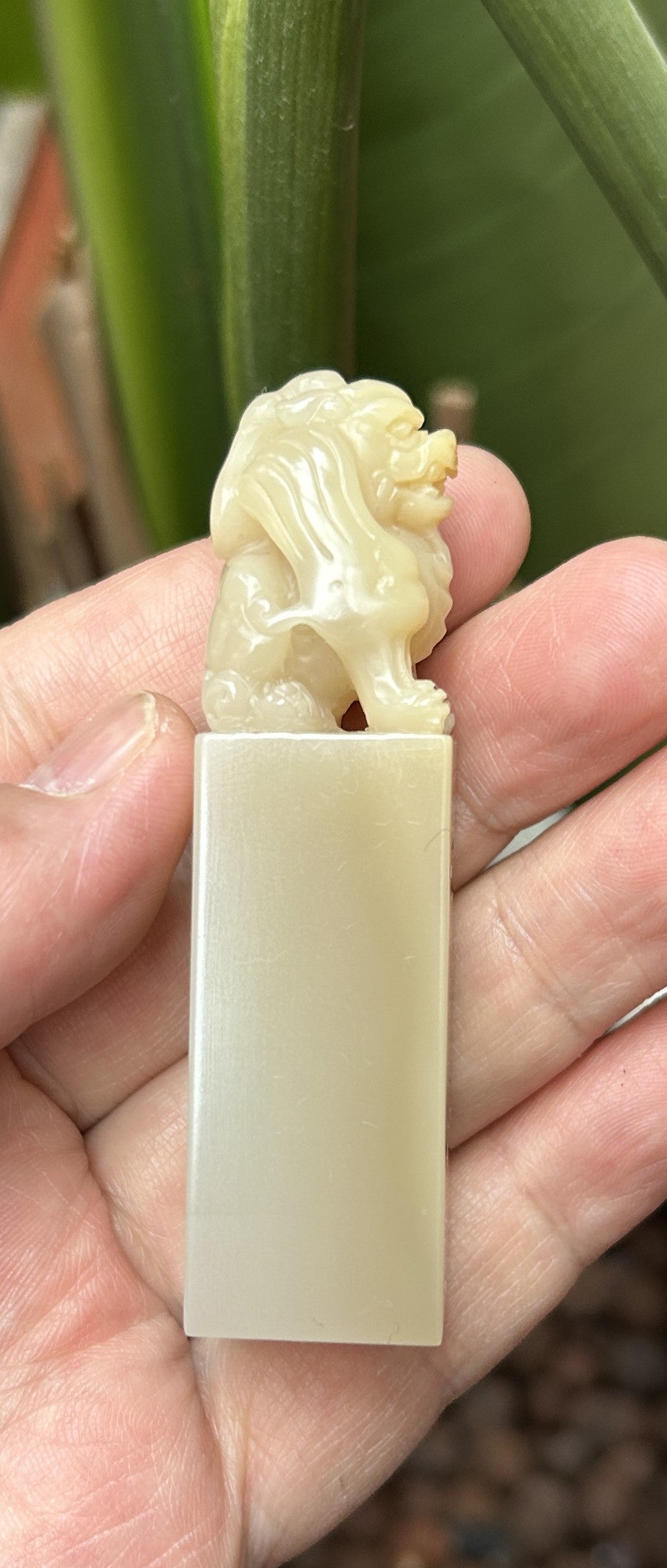 Side profile view of meticulously carved mythical lion pixiu on Laos stone seal