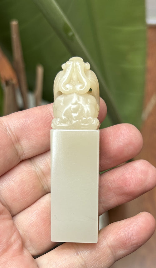 Back view of hand carved pixiu knob on translucent Laos stone square seal blank