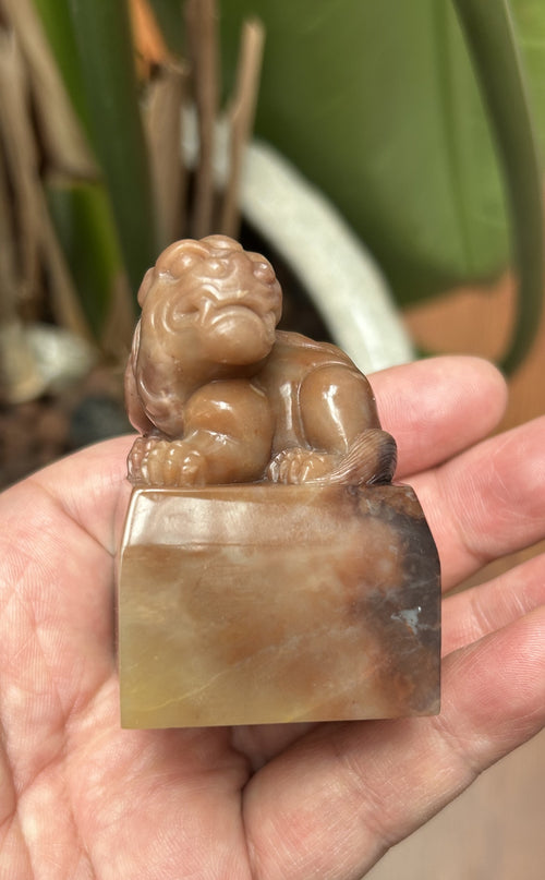 Front view detailed carved auspicious pixiu statue on polished Laos stone seal block