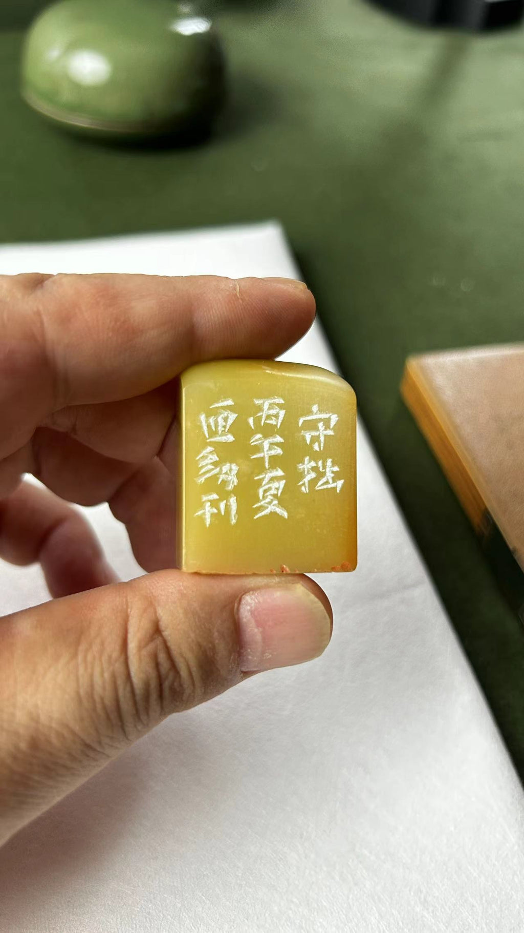 Side view of Qingtian stone seal showing hand‑engraved calligraphy inscriptions