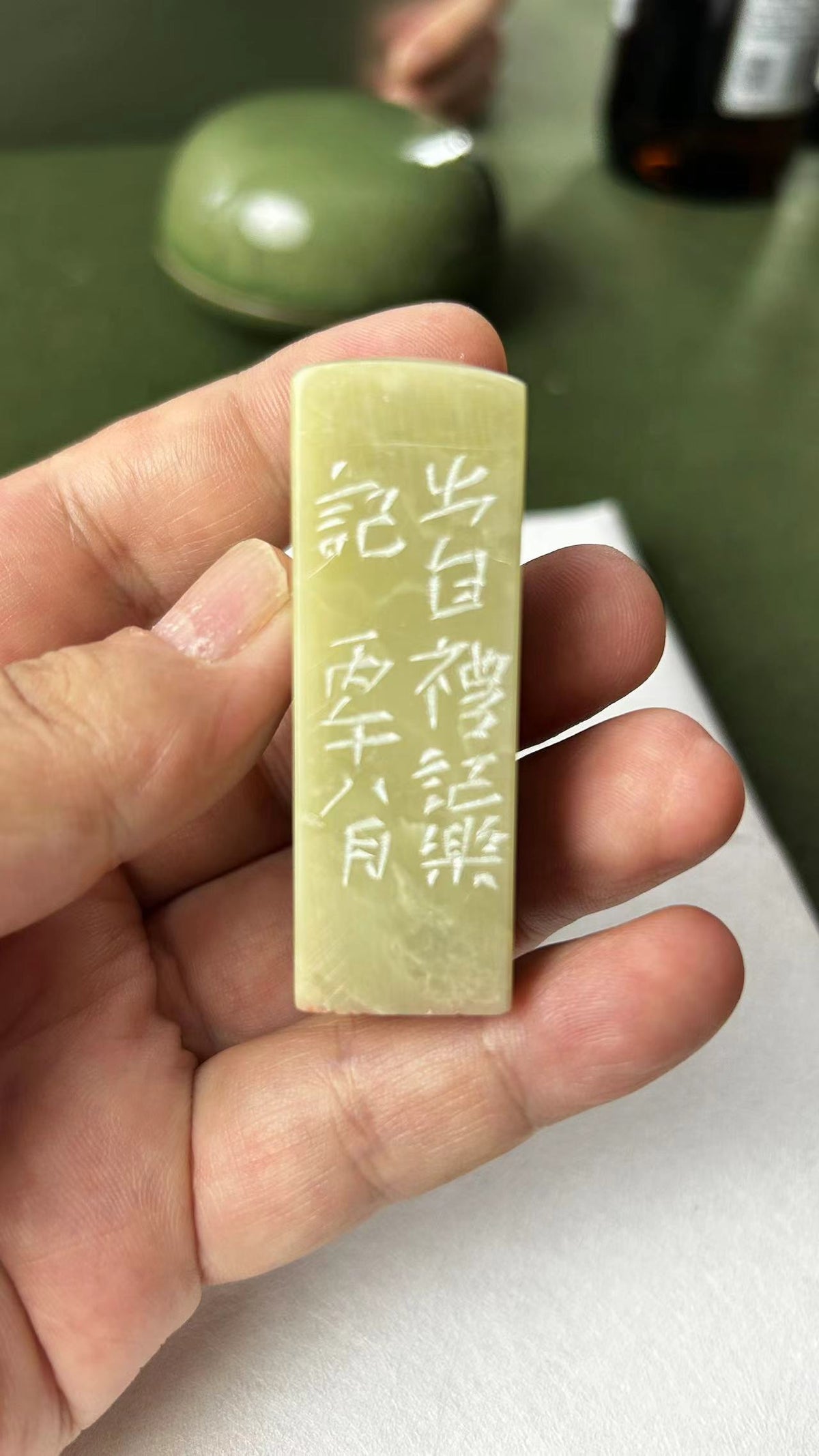 Close‑up of Qingtian seal stone, detailed side inscription carving
